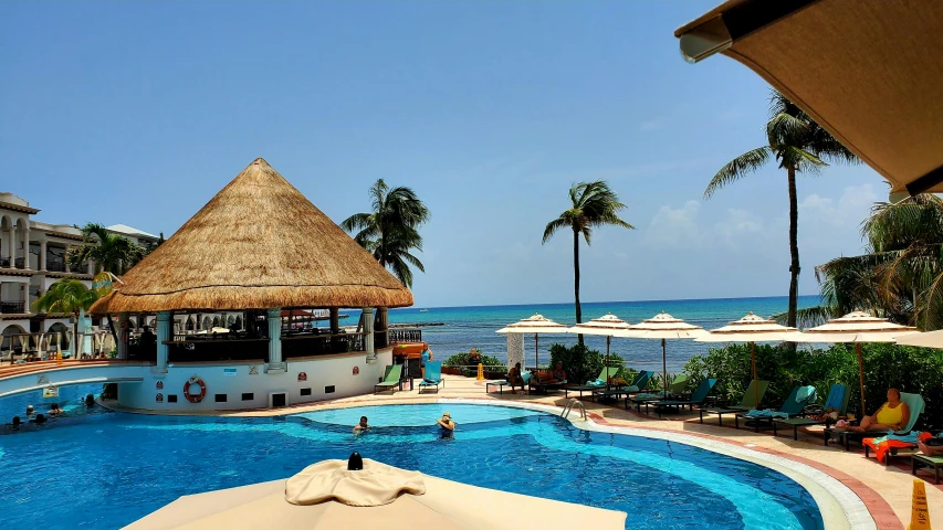 a large blue swimming pool sitting next to an ocean