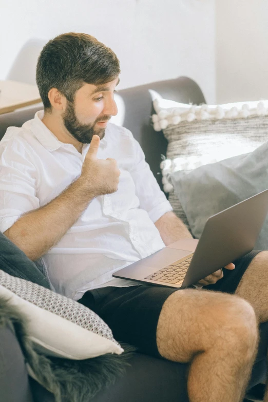 a man sitting on a couch using a laptop, pexels contest winner, giving the middle finger, h3h3, someone lost job, reddit post