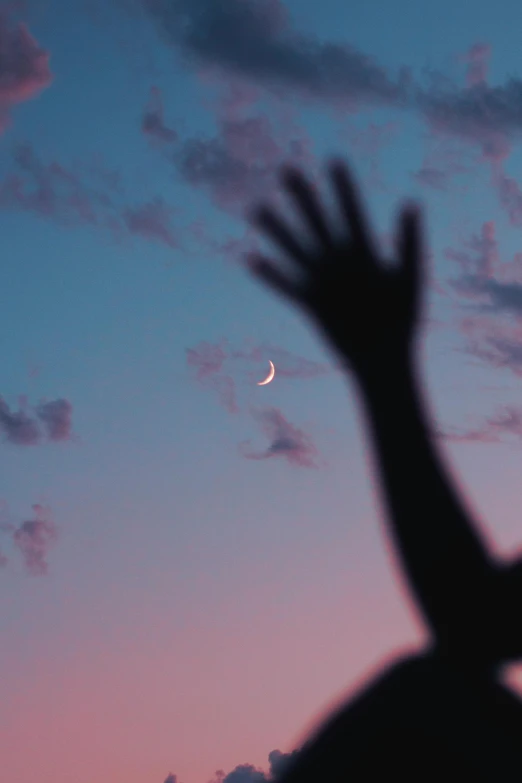 a silhouette of a person reaching up to the sky, trending on unsplash, aestheticism, shining crescent moon, pastel palette silhouette, instagram post, moons