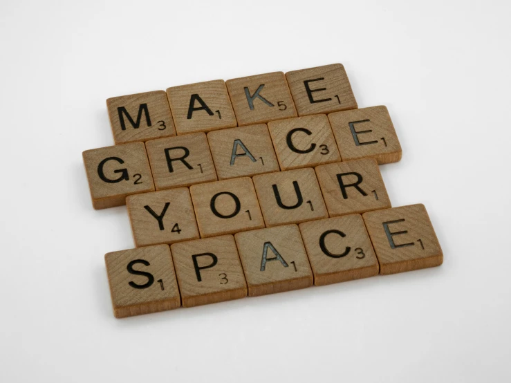 several scrabble tiles are stacked into the word make grace your space