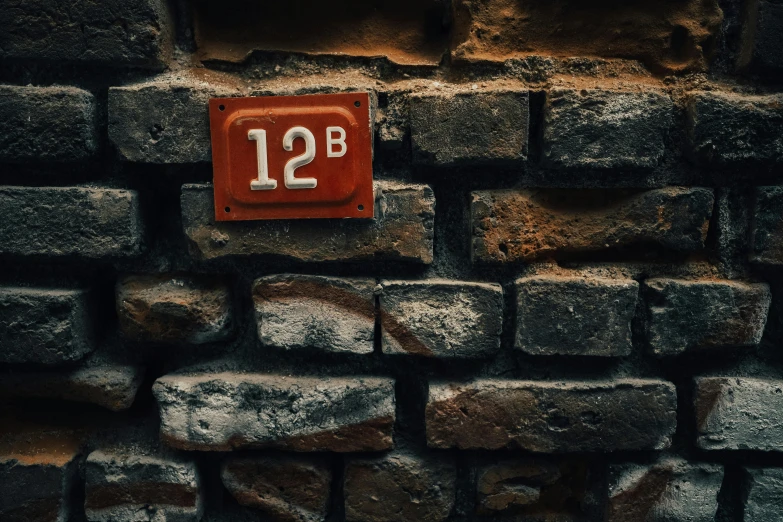 the number twelve is displayed on a brick wall