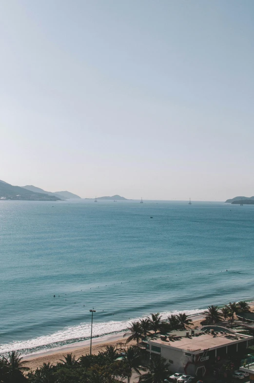 a large body of water next to a beach, by Niko Henrichon, vietnam, low quality photo, flat lay, in hong kong