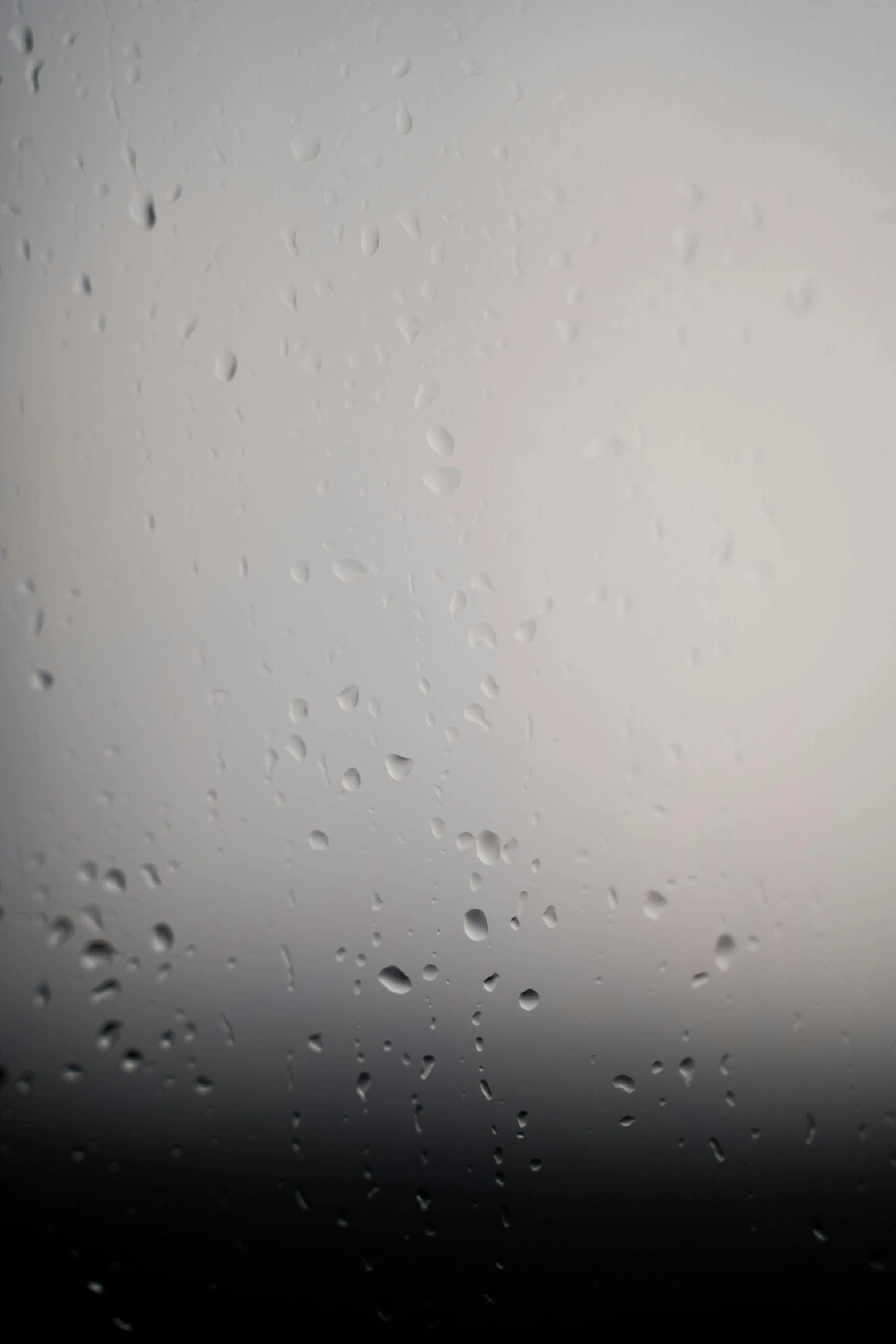 a close up of a window with raindrops on it, an album cover, inspired by Vija Celmins, unsplash, diffuse fog void, detailed white liquid, the moon on the top right, phone wallpaper