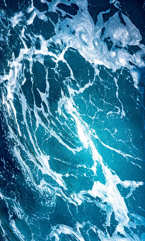 a close up of a wave in the ocean, an album cover, birdseye view, vibrant blue, slide show, commercially ready