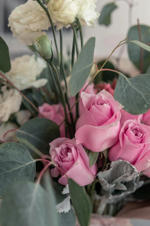 a vase filled with lots of pretty pink flowers