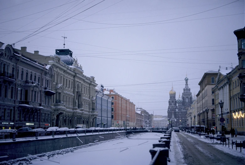 a street filled with lots of snow next to tall buildings, inspired by Vasily Surikov, pexels contest winner, hyperrealism, square, saint petersburg, canal, 2022 photograph