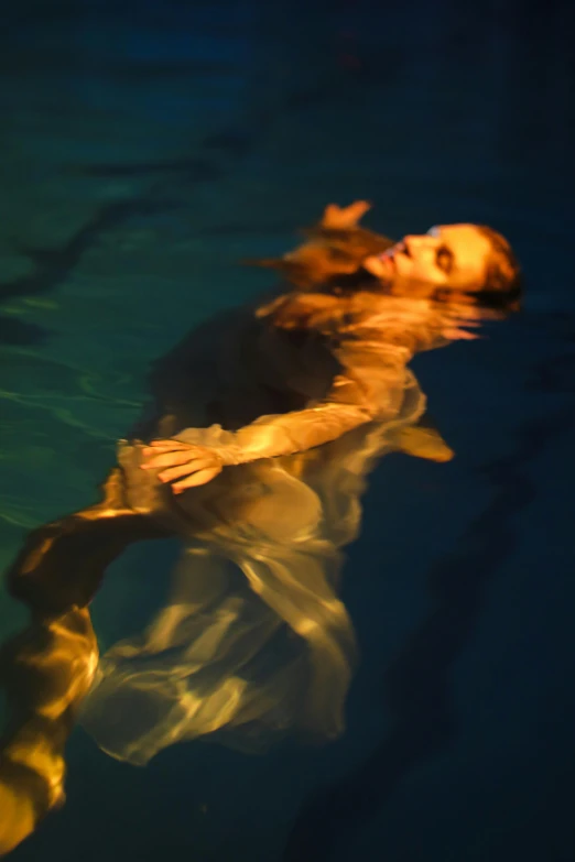 a woman floating in a pool with a frisbee, inspired by Brooke Shaden, ultrafine detail ”, david kassan, low light, fish swimming