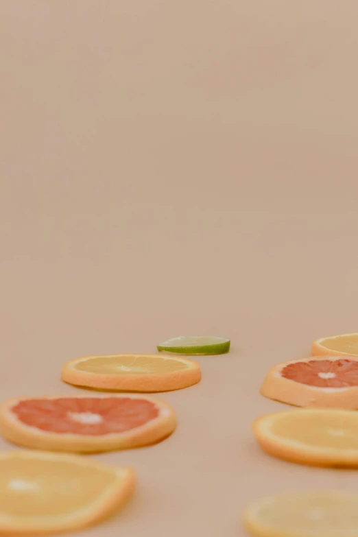 a group of slices of grapefruit sitting on top of each other, trending on pexels, photorealism, clemens ascher, scene from a dinner party, abstract claymation, lime