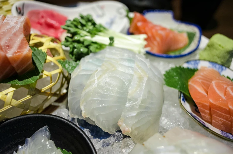 sushi plates, bowls and vegetables that have been seasoned for cooking