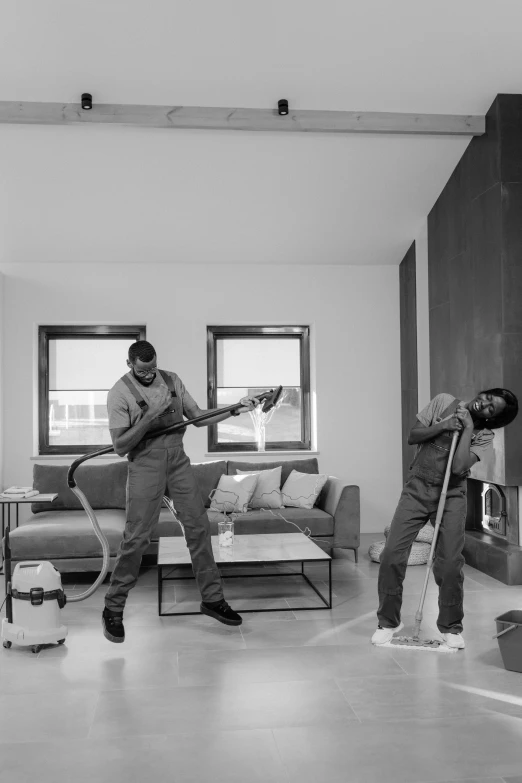 a black and white photo of two men cleaning a living room, by Sebastian Spreng, playboi carti and lil uzi vert, clean bright happy, antoine-jean gr, vacuum