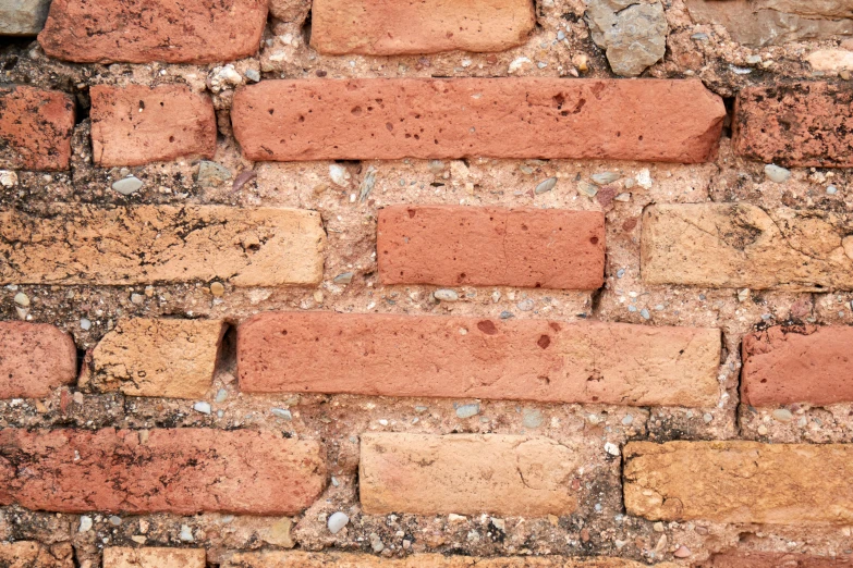 there is a old brick wall made from red bricks