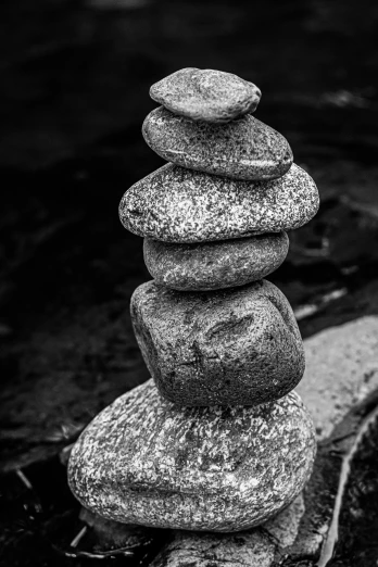 a pile of rocks stacked on top of each other, a black and white photo, inspired by Edward Weston, 8k 50mm iso 10, color splash, f / 8, ansel ]