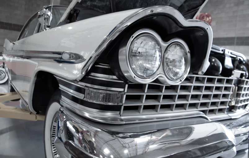 a black and white photo of a classic car, by Joe Bowler, pexels contest winner, photorealism, custom headlights, pastel', metal chrome, mercury