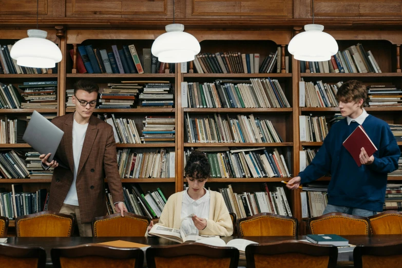 a group of people standing around a table in a library, by Jang Seung-eop, pexels contest winner, full body image, brown, thumbnail, dramedy