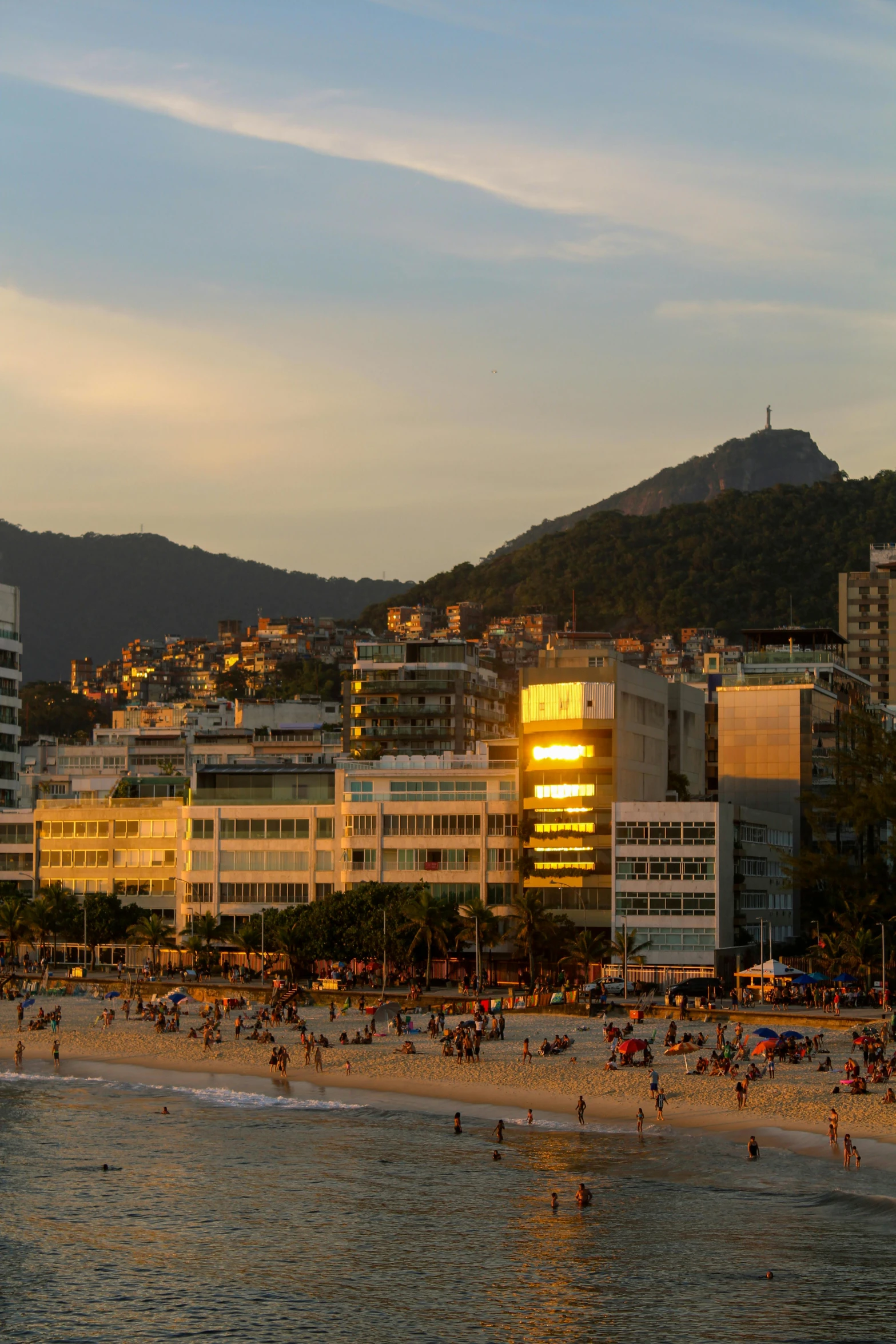 the beach is crowded with people and buildings in front of them