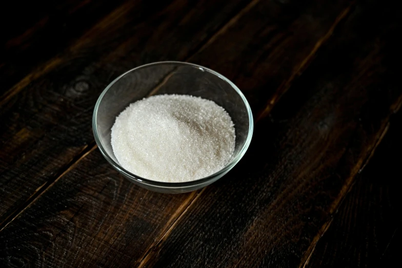 a bowl of sugar sitting on top of a wooden table, product image, fan favorite, gelatine silver process, medium shot angle