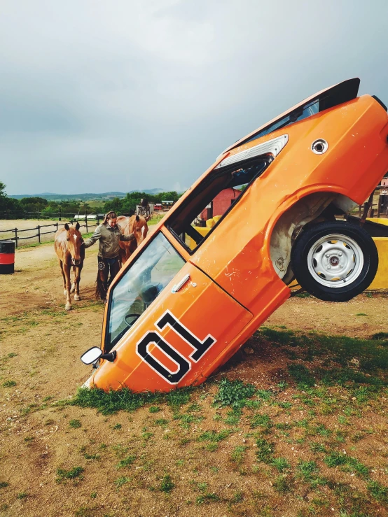 a car that is upside down in a field, a cartoon, unsplash, photorealism, horse on top, orange body, in an arena pit, 🤠 using a 🖥