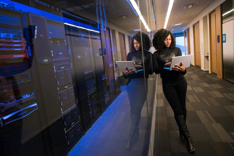 a woman standing in front of a glass wall, pacing in server room, photo of a black woman, computer network, avatar image