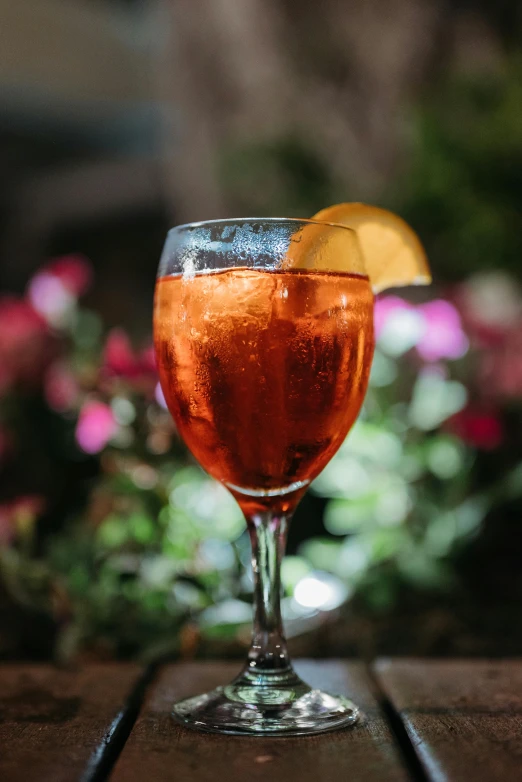 the drinks are on the table with pink flowers in the background