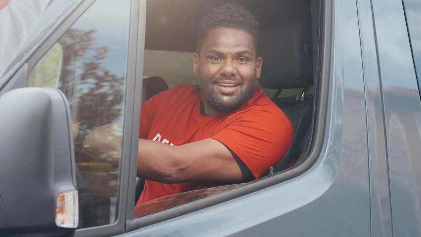 a man sitting in the driver's seat of a van, a portrait, mkbhd, smiling spartan, profile image, portrait image