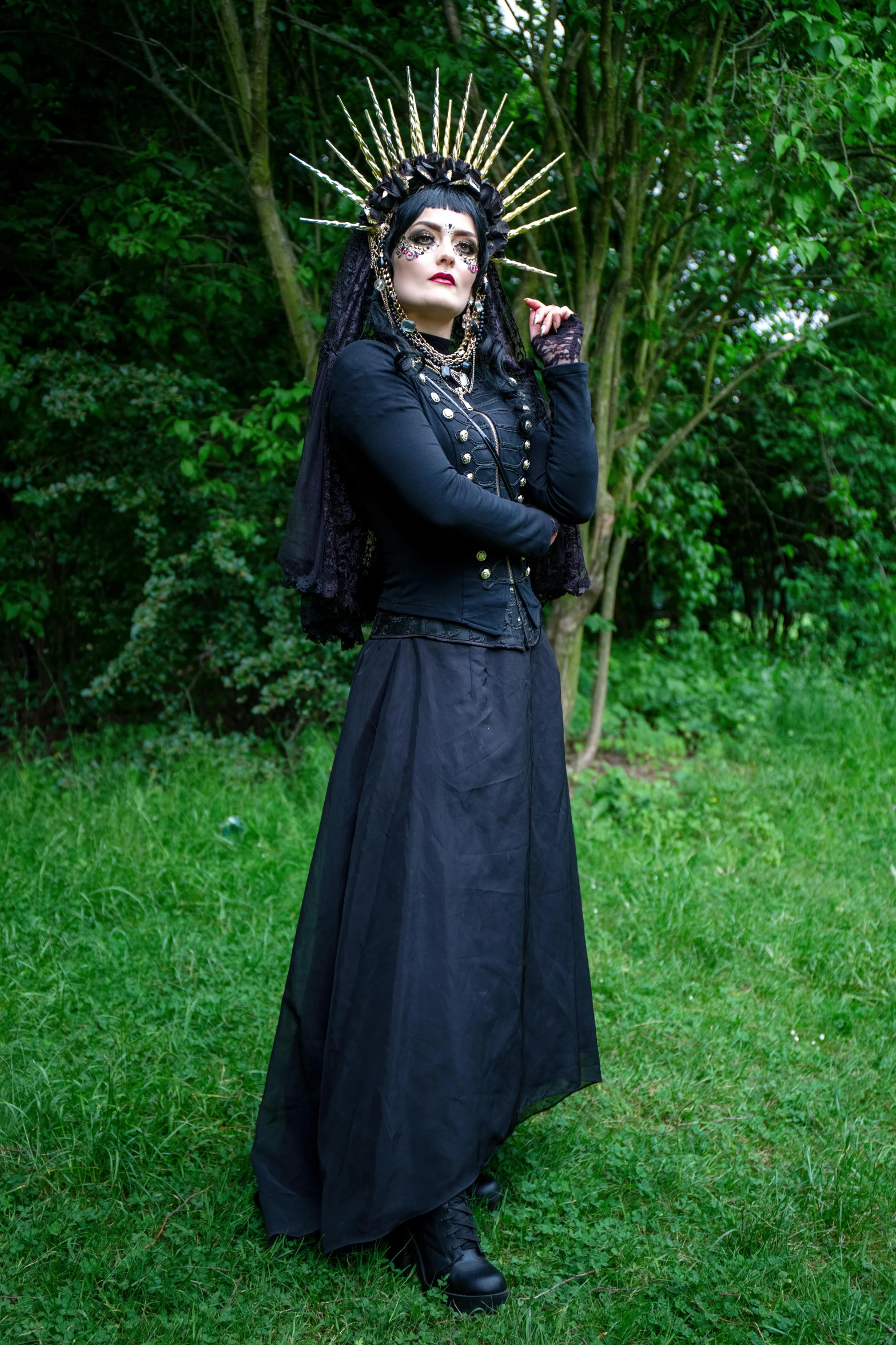 a woman in a black dress with a crown on her head, an album cover, inspired by Eleanor Fortescue-Brickdale, renaissance, witchcore clothes, photograph taken in 2 0 2 0, wearing black vest and skirt, outside