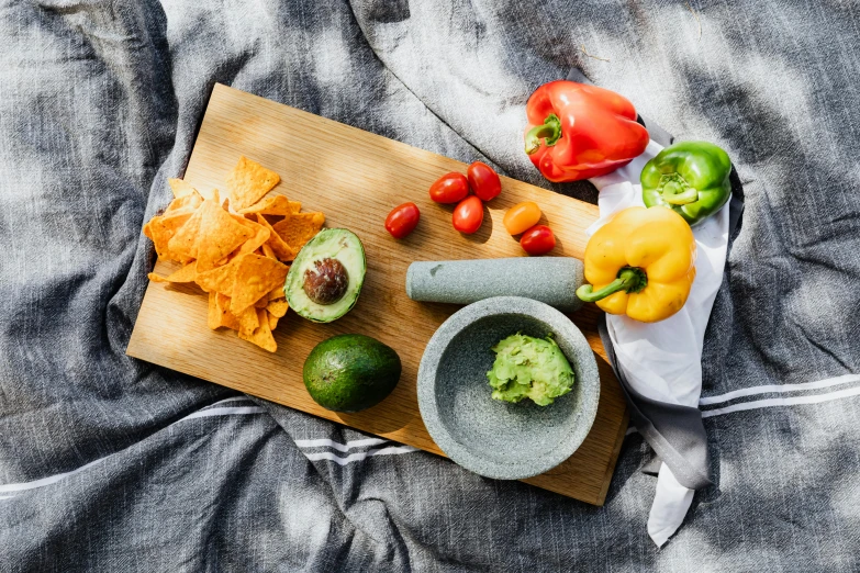 a wooden cutting board topped with tortillas and guacamole, a still life, inspired by Ceferí Olivé, unsplash, fruit bowl, background image