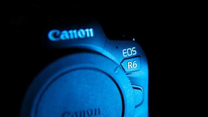 a close up of a camera in the dark, canon eos r 6, blue neon, r-number, rb 6 s