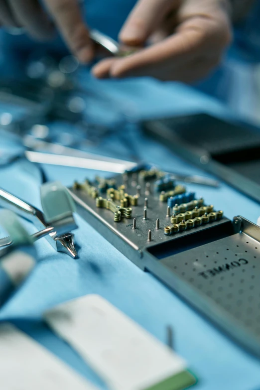 a close up of a bunch of tools on a table, a microscopic photo, happening, surgery theatre, thumbnail, circuitry, implants