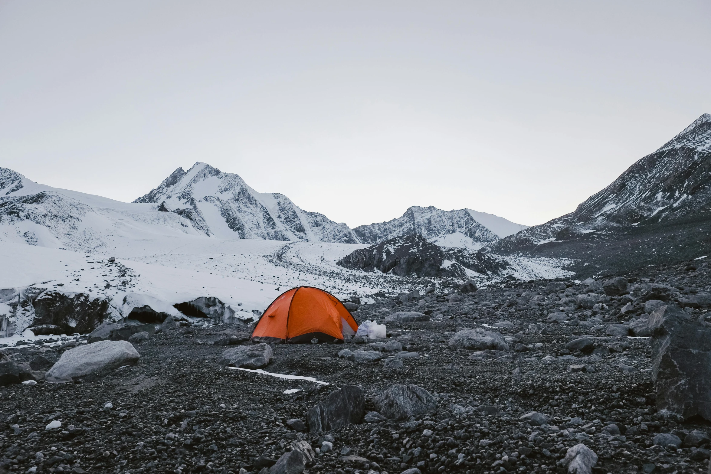 an orange tent sitting on top of a rocky field, unsplash contest winner, hurufiyya, glaciers and ice and snow, avatar image, gravel and scree ground, campsites