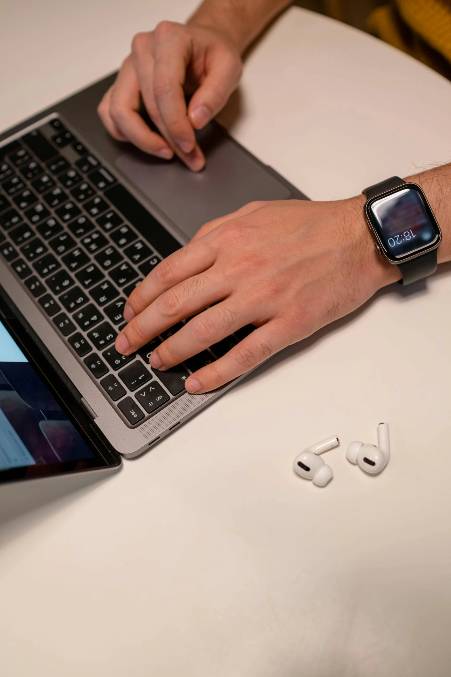 a man sitting at a table using a laptop computer, a computer rendering, pexels, earbuds jewelry, wearing a watch, with apple, thumbnail