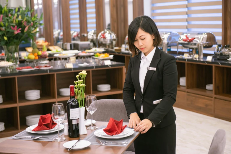 a woman standing at a dining room table