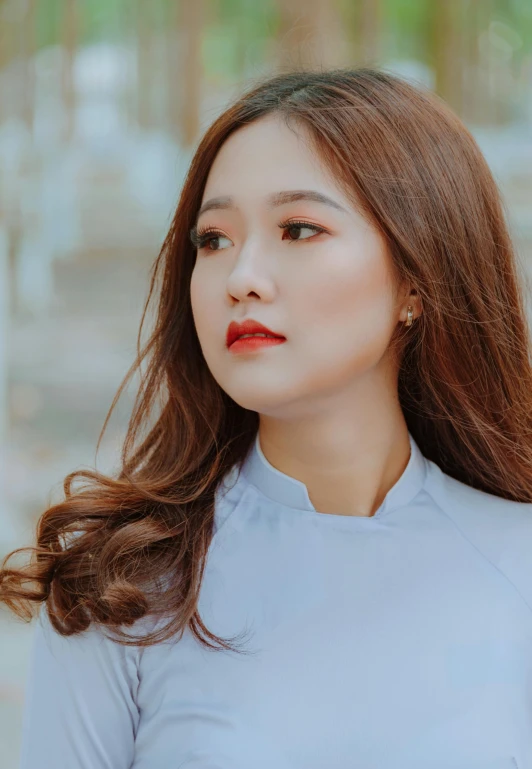 a woman with long hair wearing a blue shirt, inspired by Kim Jeong-hui, pexels contest winner, light-red lips, square, vietnamese woman, large)}]