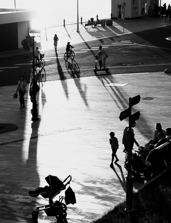 a black and white photo of a group of people, inspired by Ruth Orkin, realism, cinematic. by leng jun, taken at golden hour, bird\'s eye view, in sao paulo