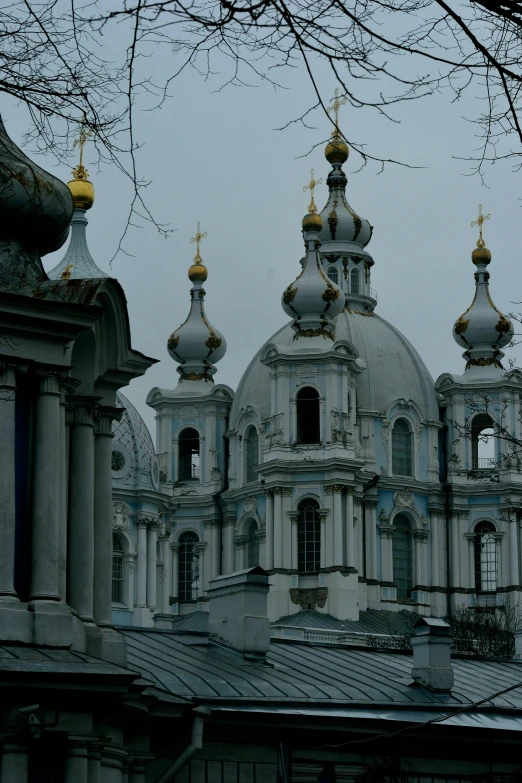 a large building with a clock on top of it, inspired by Illarion Pryanishnikov, baroque, black domes and spires, gray sky, galaxy + baroque, tomb