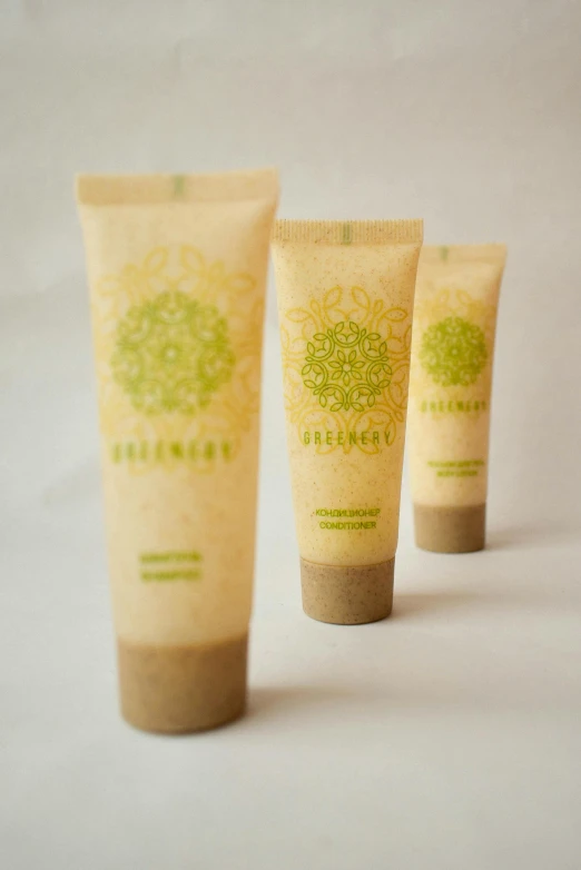 three tubes sitting next to each other on a white surface, a picture, behance, renaissance, geeen skin, sol retreat, carved soap, yellow seaweed