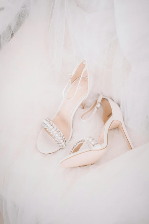 a pair of wedding shoes sitting on top of a bed, inspired by Perle Fine, trending on pexels, renaissance, top angle view, product introduction photo, white, thumbnail