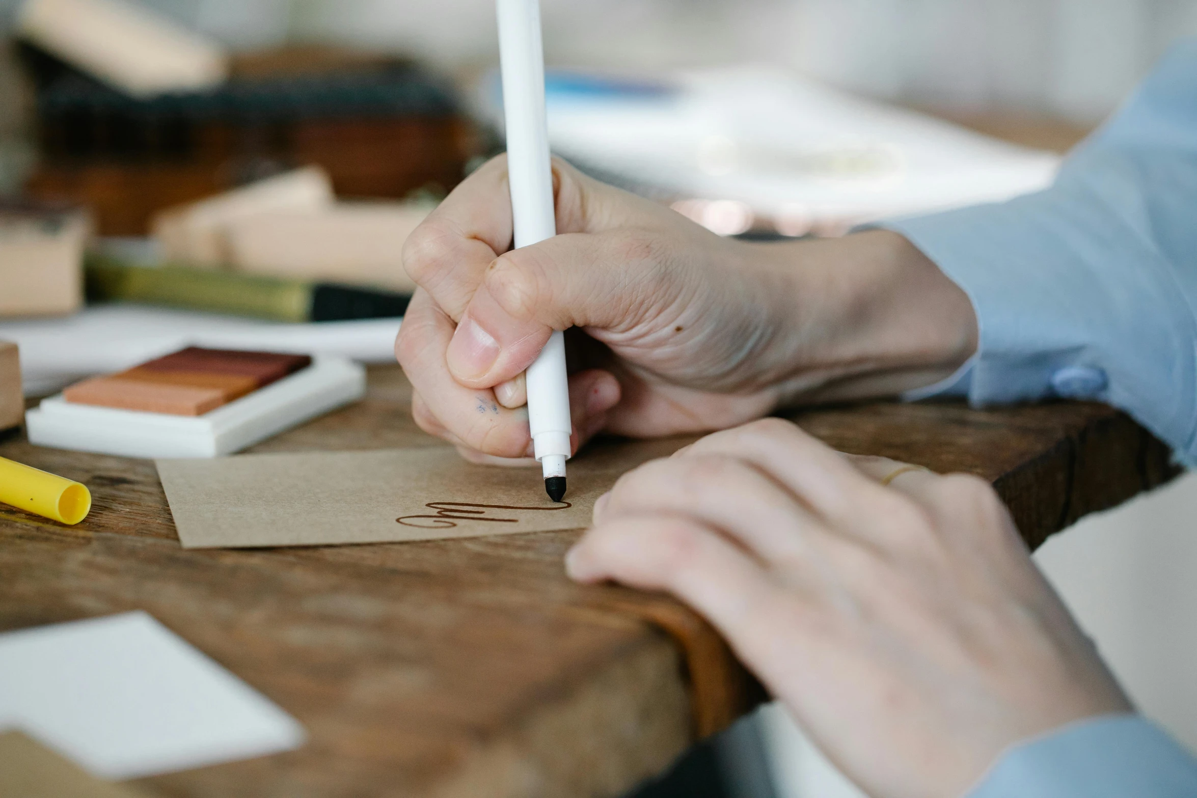 a person working on an object with their hand on a small paper