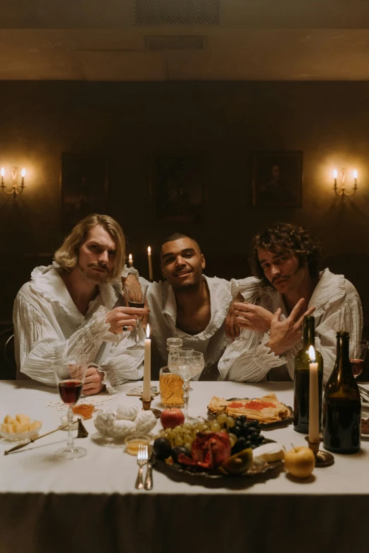 three men sitting at the table holding wine glasses