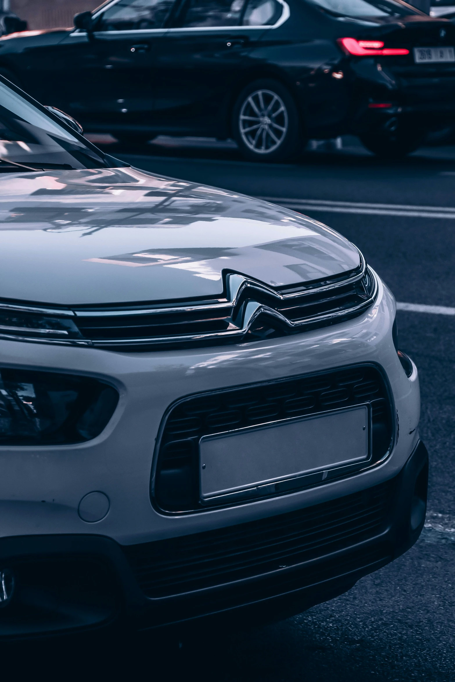 a very bright silver car parked by the curb