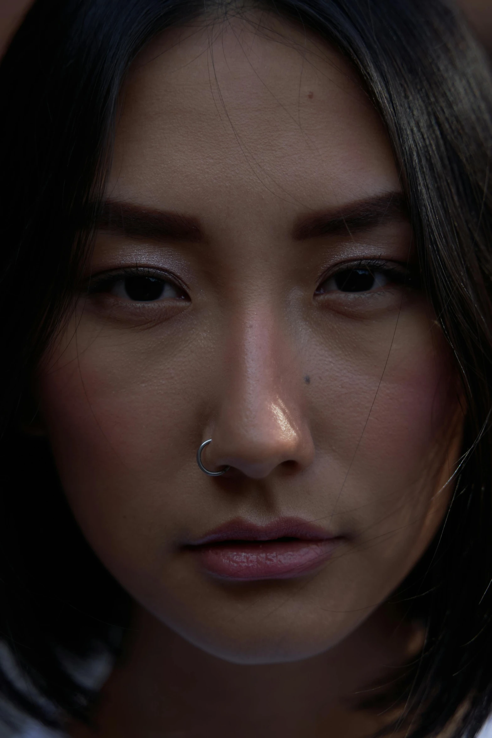 a close up of a person with a cell phone, a character portrait, inspired by Jung Park, pexels contest winner, hyperrealism, young himalayan woman, ethnicity : japanese, face illuminated, nose ring