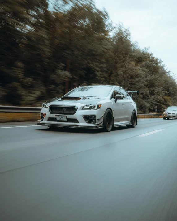 two white cars on the road side by side