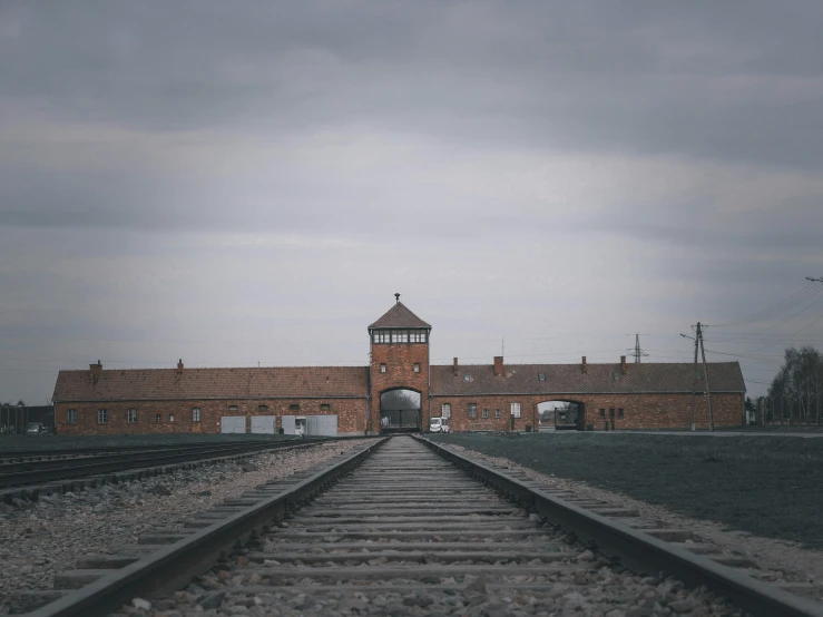 railroad tracks with a view of the brick building