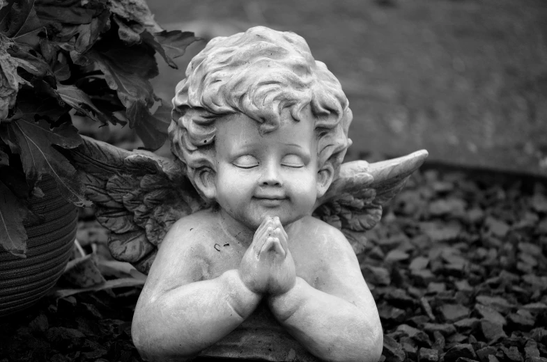 a black and white photo of a little angel, a statue, pexels, happy face, biblically acurate angel, a quaint, amusing