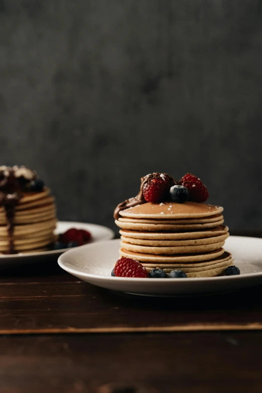 a stack of pancakes sitting on top of a white plate, unsplash, kek, berries, cinematic medium shot, brown