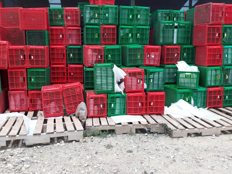 a pile of crates sitting on top of a wooden pallet, a picture, instagram, plasticien, red and green, chicken, contain, nets