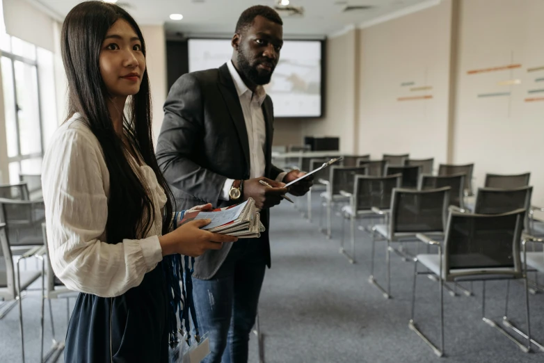 two people standing next to each other in a room, happening, educational, in australia, diversity, technology