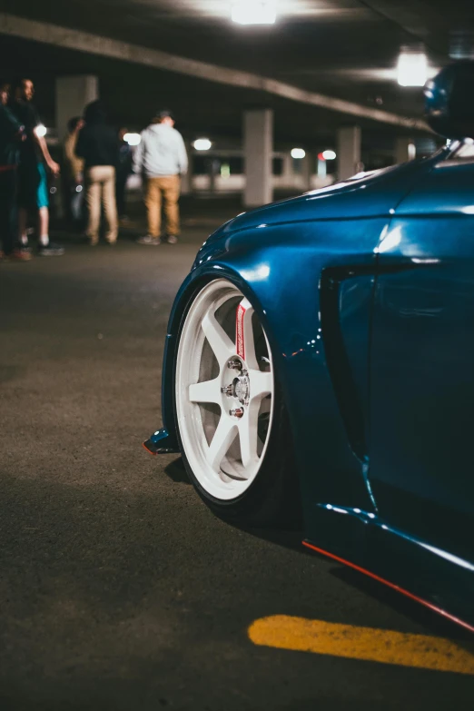 close up view of a blue sport car on an outdoor parking garage