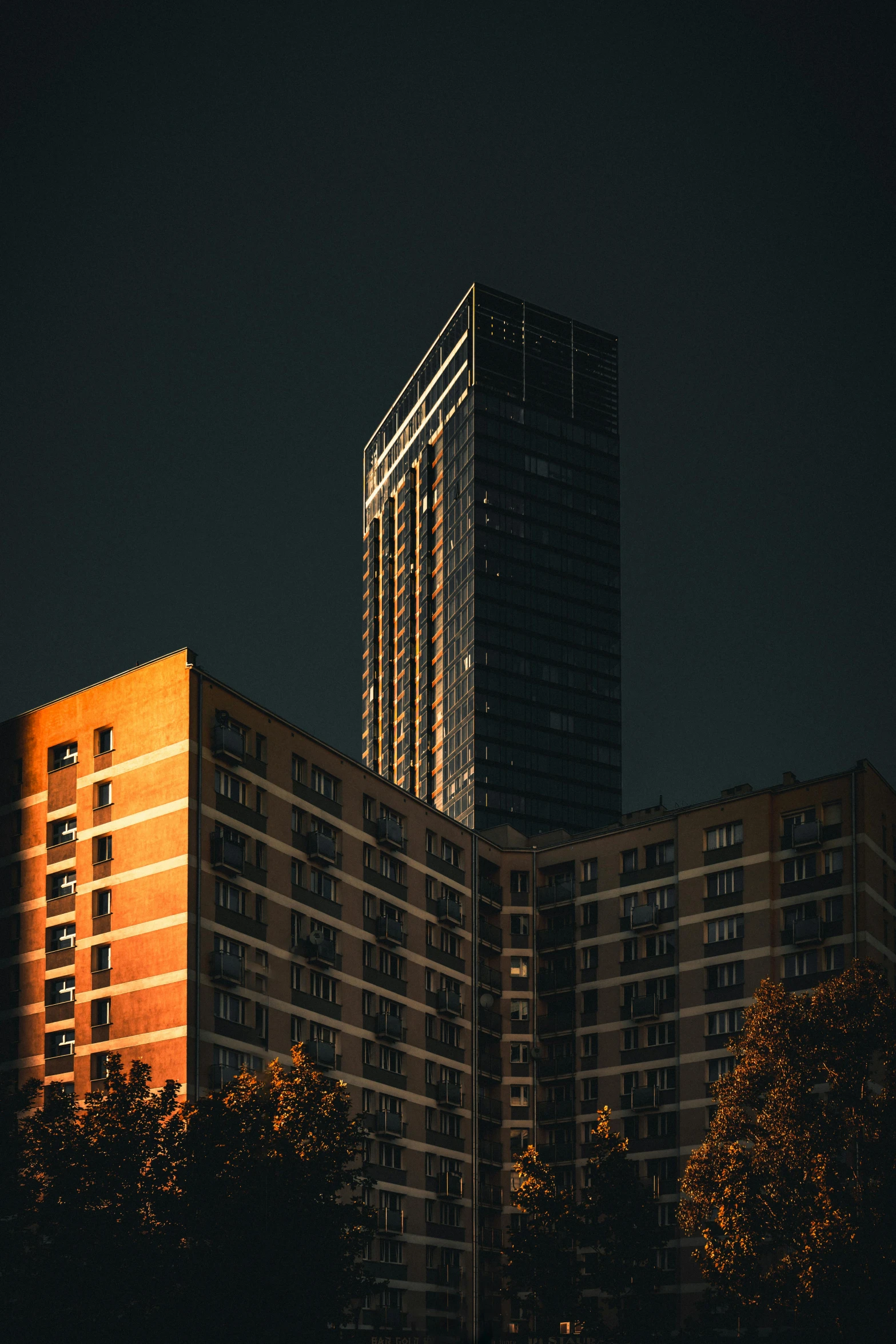 a very large tall building next to a very tall building