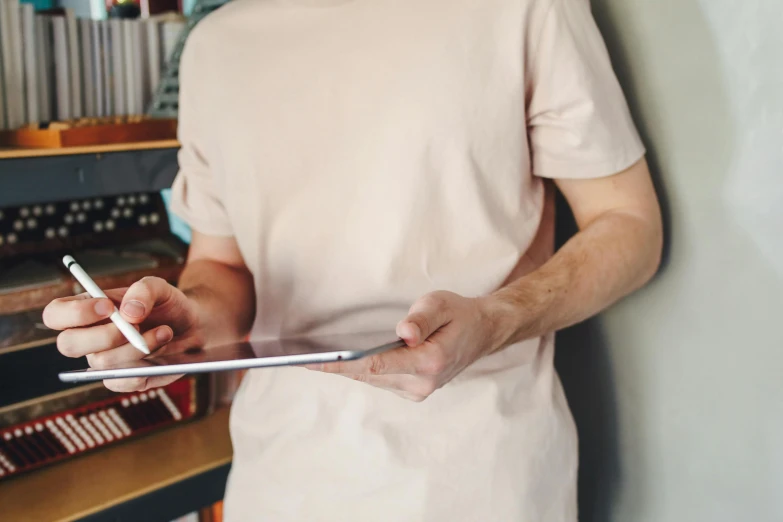 a man holding a tablet and a cigarette in his hand, trending on pexels, printed on a cream linen t-shirt, holding a clipboard, open v chest clothes, thumbnail