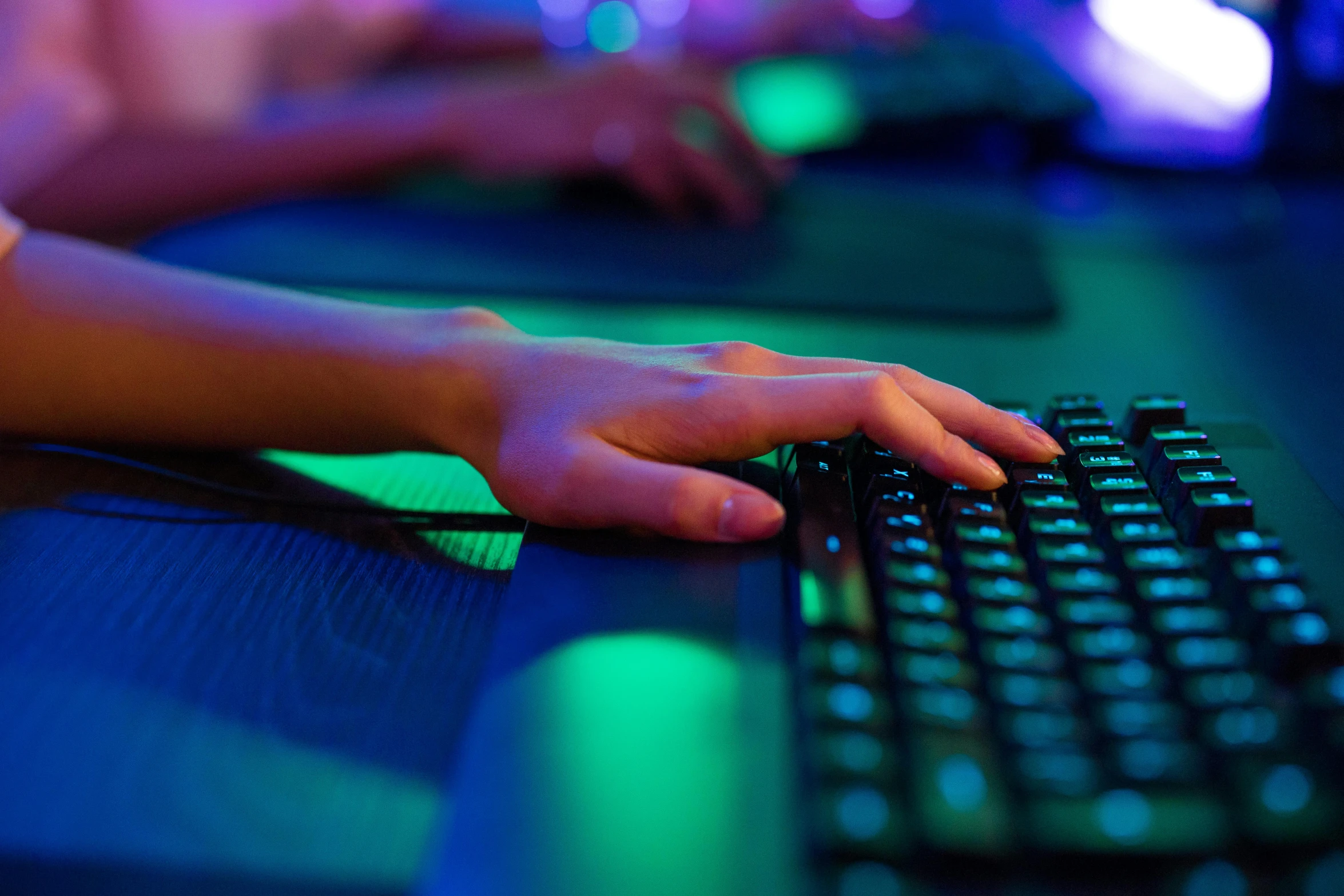 a close - up of the hands and keyboard of a person using a mouse